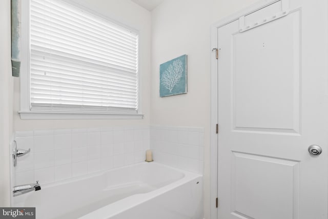 bathroom with a bathing tub and a wealth of natural light