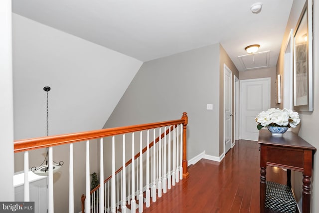 hall with dark hardwood / wood-style flooring and vaulted ceiling