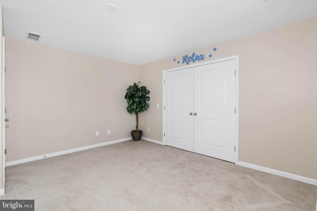 unfurnished bedroom featuring light colored carpet