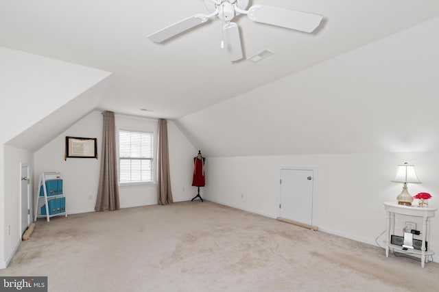 additional living space featuring light carpet, vaulted ceiling, and ceiling fan