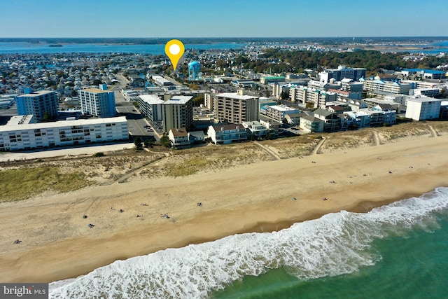 birds eye view of property with a water view and a view of the beach