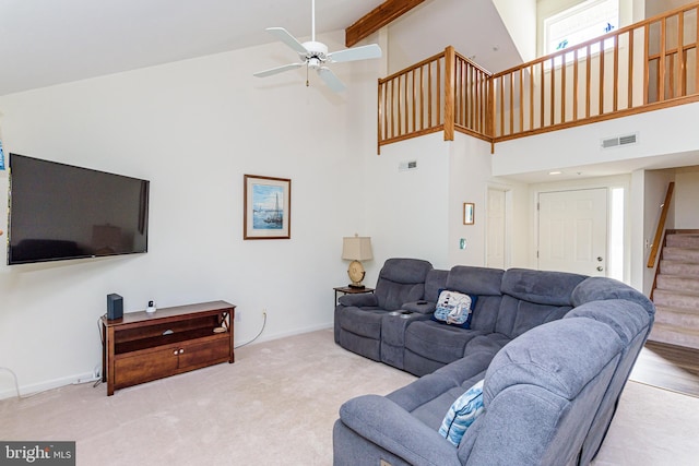 living room with ceiling fan, high vaulted ceiling, and light colored carpet