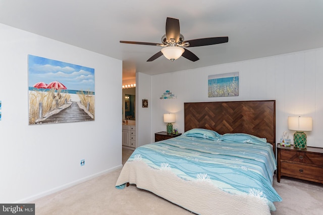 bedroom with connected bathroom, carpet, and ceiling fan