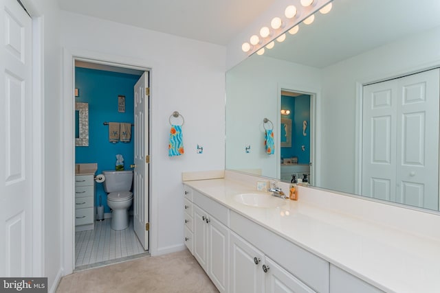 bathroom with vanity, toilet, and tile patterned flooring