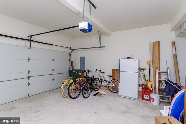 garage with white fridge, a garage door opener, and electric panel