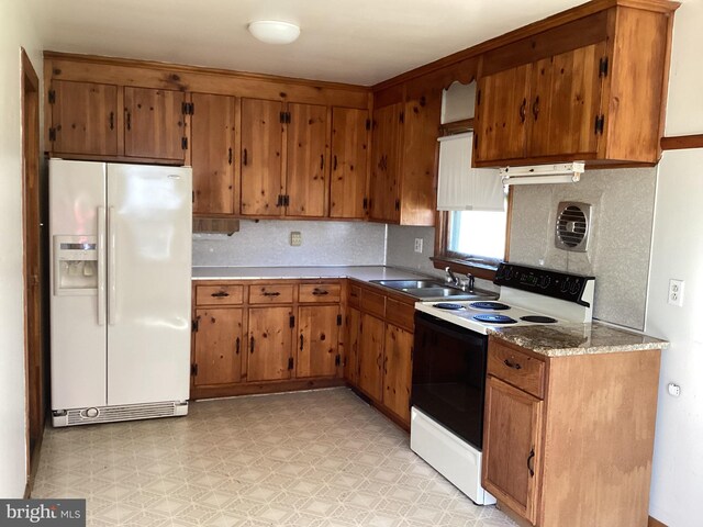 17604 Woodlawn Dr, Hagerstown, MD 21740 - kitchen with white appliances, brown cabinets, backsplash, and a sink