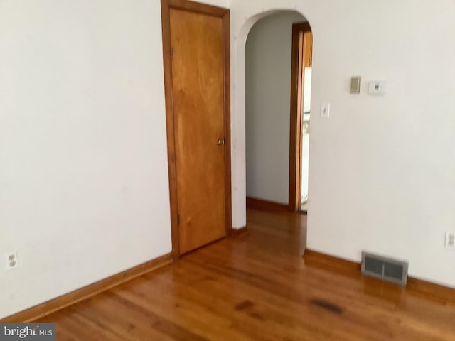 17604 Woodlawn Dr, Hagerstown, MD 21740 - empty room with wood finished floors, visible vents, and arched walkways