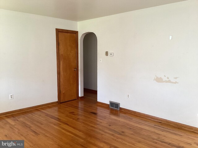 17604 Woodlawn Dr, Hagerstown, MD 21740 - unfurnished room with wood finished floors, baseboards, visible vents, and arched walkways