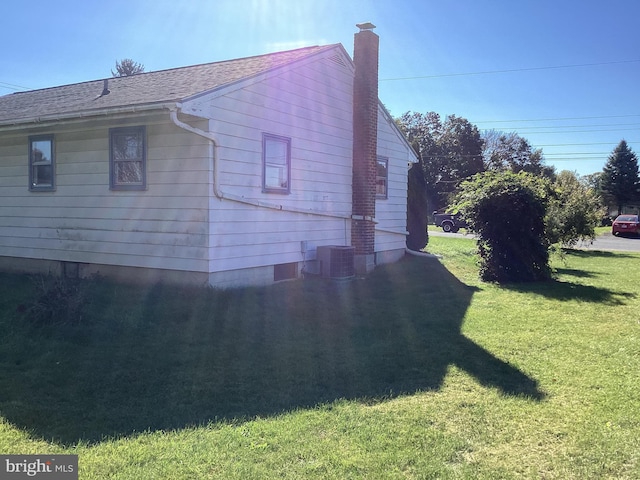 17604 Woodlawn Dr, Hagerstown, MD 21740 - view of property exterior with a chimney, a shingled roof, cooling unit, and a lawn