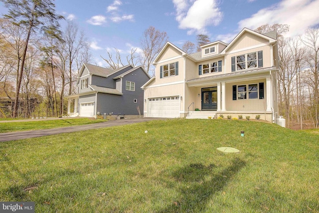 view of front of house with french doors, a front lawn, covered porch, and a garage