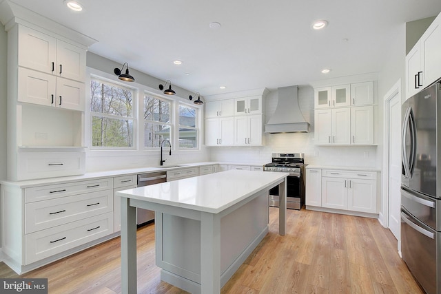 127 Shore Rd, Arnold, MD 21012 - kitchen featuring appliances with stainless steel finishes, custom exhaust hood, a sink, a kitchen breakfast bar, and decorative backsplash