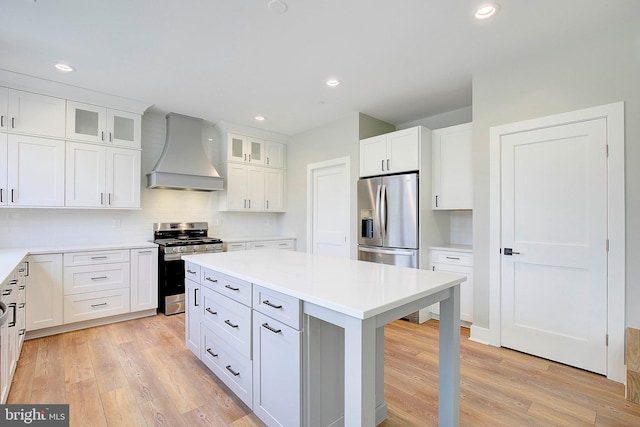 127 Shore Rd, Arnold, MD 21012 - kitchen featuring custom range hood, stainless steel appliances, light wood-type flooring, a kitchen island, and recessed lighting
