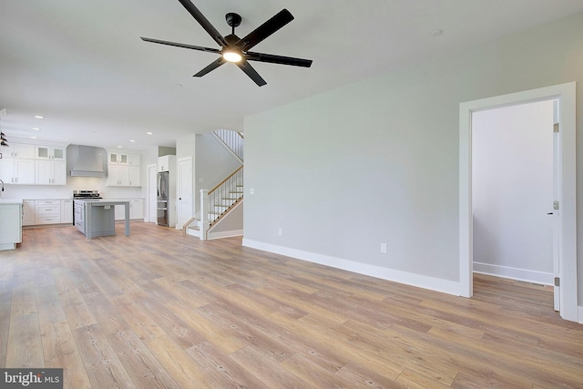 127 Shore Rd, Arnold, MD 21012 - unfurnished living room featuring stairway, a ceiling fan, light wood-style flooring, recessed lighting, and baseboards
