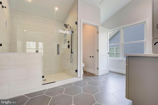 127 Shore Rd, Arnold, MD 21012 - full bath featuring a shower stall, vaulted ceiling, toilet, tile patterned floors, and healthy amount of natural light