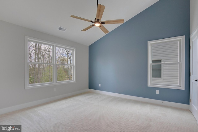 empty room with ceiling fan, light colored carpet, and lofted ceiling