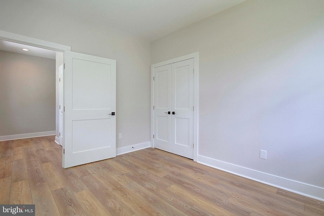 unfurnished bedroom featuring light wood-type flooring