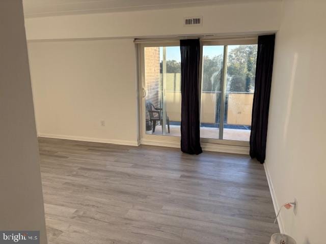 spare room with hardwood / wood-style floors