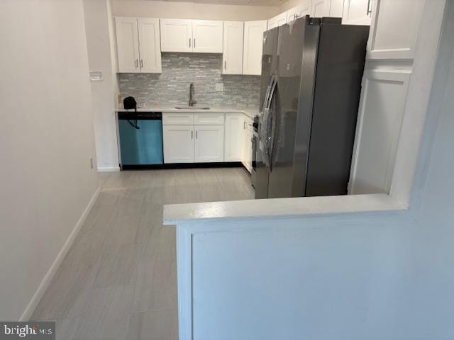 kitchen with white cabinetry, backsplash, appliances with stainless steel finishes, and sink