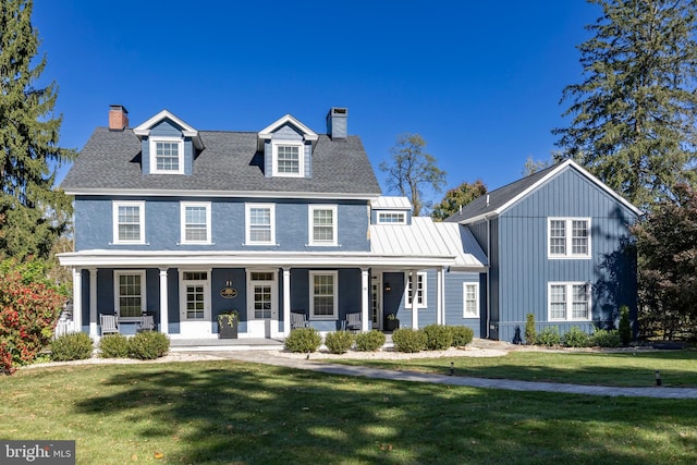 view of front of property with a front yard and covered porch