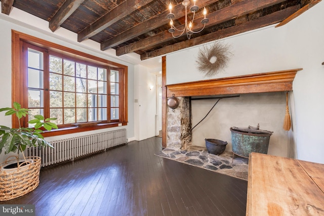 room details with beam ceiling, hardwood / wood-style floors, and radiator