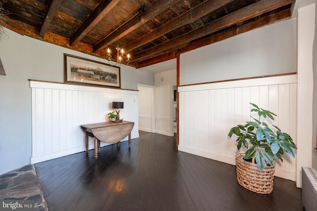 miscellaneous room featuring beamed ceiling, radiator heating unit, wooden ceiling, and dark hardwood / wood-style flooring