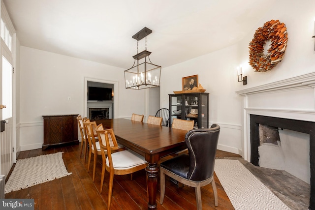 dining area with a chandelier and dark hardwood / wood-style floors