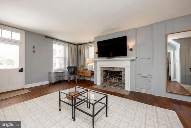 living room with radiator and hardwood / wood-style flooring