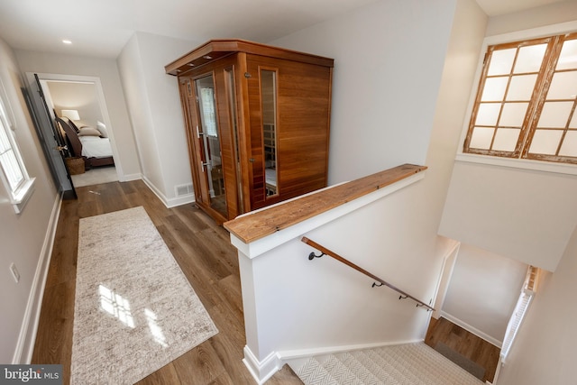 hallway with hardwood / wood-style flooring