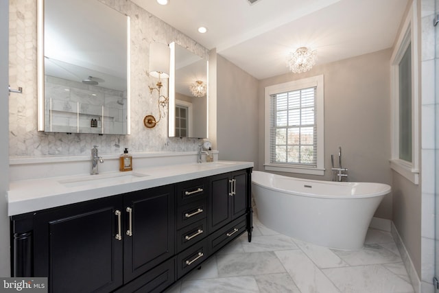 bathroom with vanity, a chandelier, and plus walk in shower