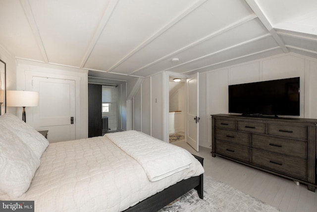 bedroom with lofted ceiling and ensuite bathroom