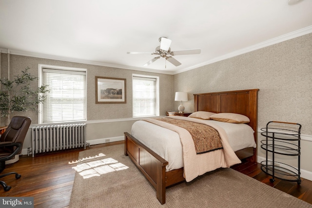 bedroom featuring ornamental molding, multiple windows, radiator heating unit, and dark hardwood / wood-style floors