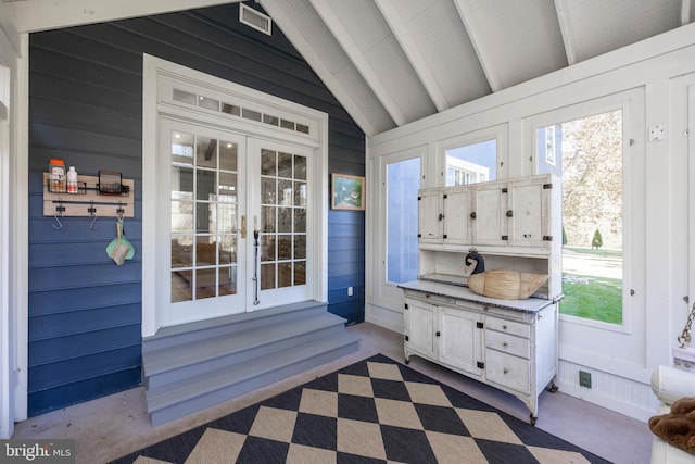 sunroom featuring vaulted ceiling with beams and french doors