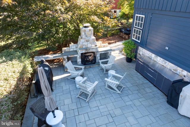 view of patio with an outdoor stone fireplace