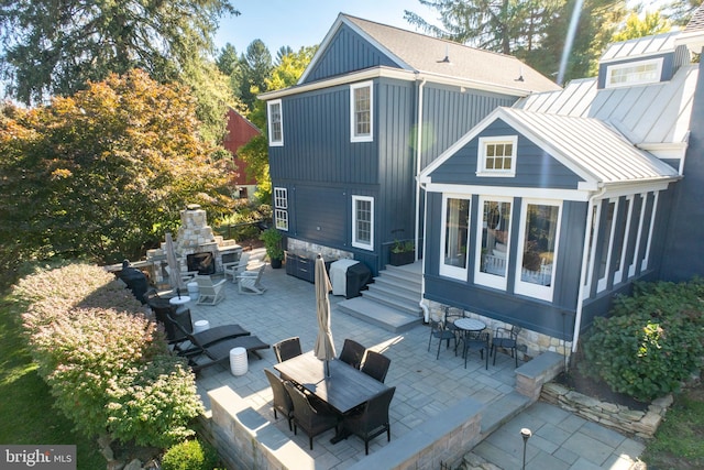 back of property featuring a sunroom and a patio area