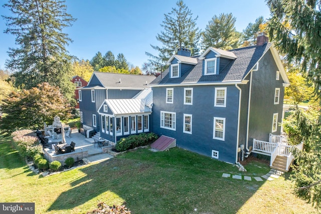 rear view of property with a patio area and a lawn