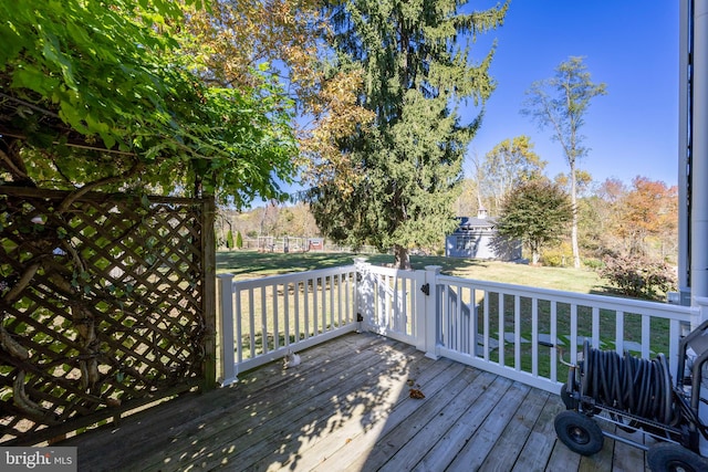 wooden deck with a lawn