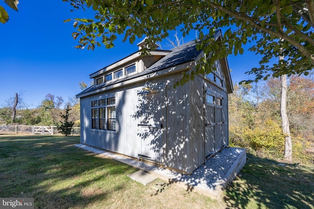 view of home's exterior featuring a storage shed and a lawn