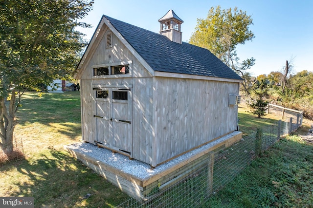 view of outbuilding featuring a yard