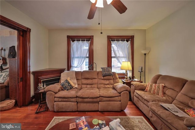 living room with hardwood / wood-style flooring and ceiling fan