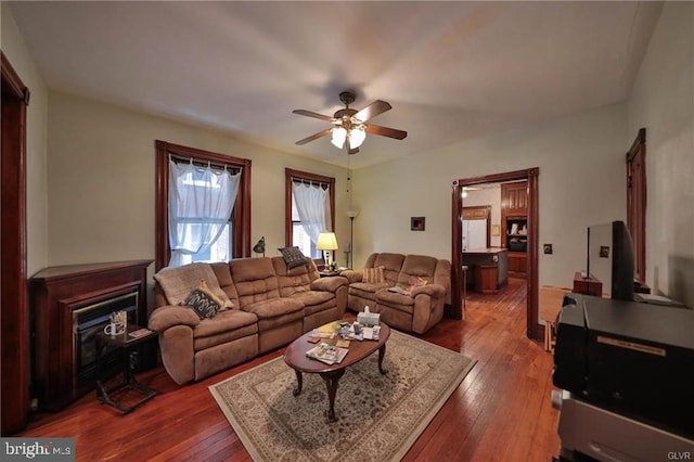 living room featuring ceiling fan and hardwood / wood-style flooring