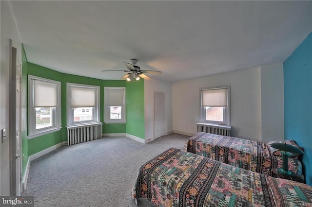 bedroom with light carpet, radiator heating unit, and ceiling fan