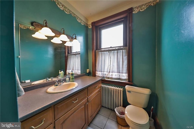 bathroom featuring vanity, tile patterned flooring, toilet, and radiator