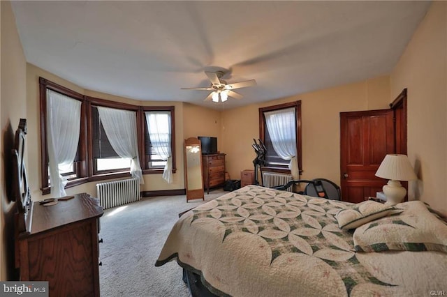 bedroom featuring radiator, ceiling fan, and light carpet