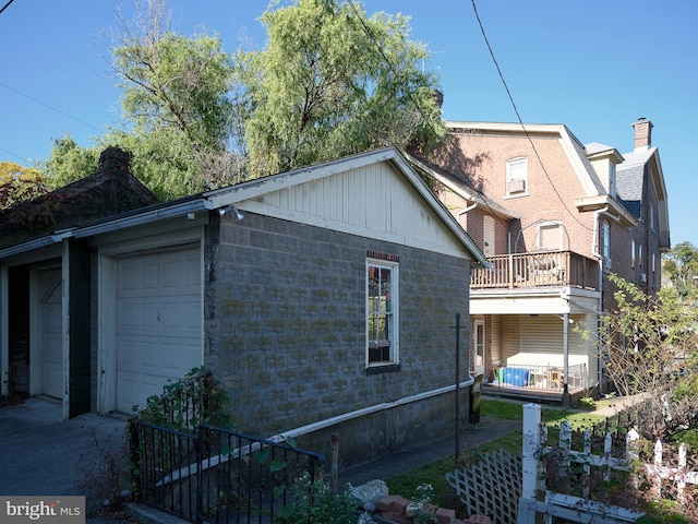 view of home's exterior with a balcony and a garage