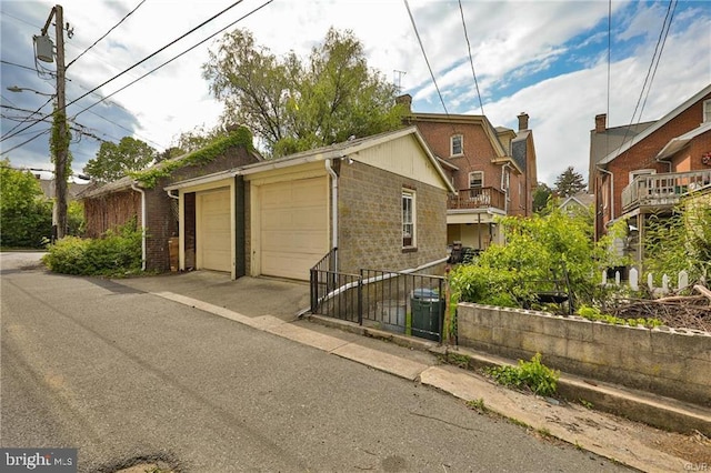 exterior space with a garage and a balcony