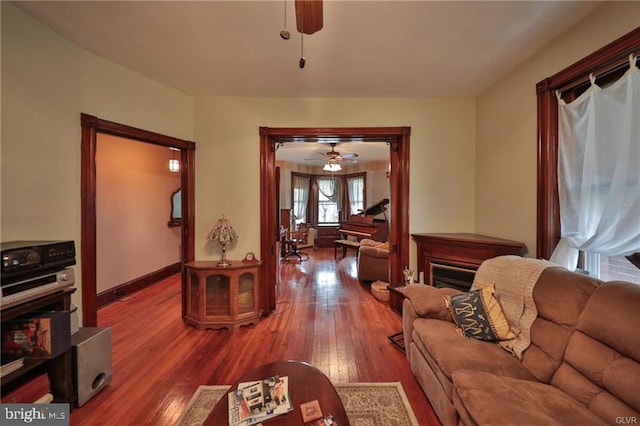 living room featuring wood-type flooring and ceiling fan