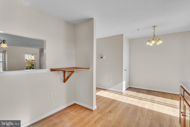 interior space featuring hardwood / wood-style flooring and a chandelier