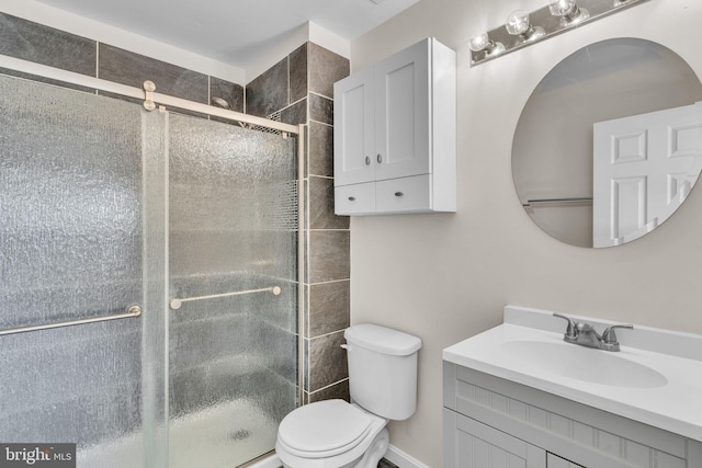 bathroom with vanity, toilet, and walk in shower