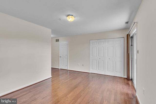 unfurnished bedroom featuring hardwood / wood-style flooring