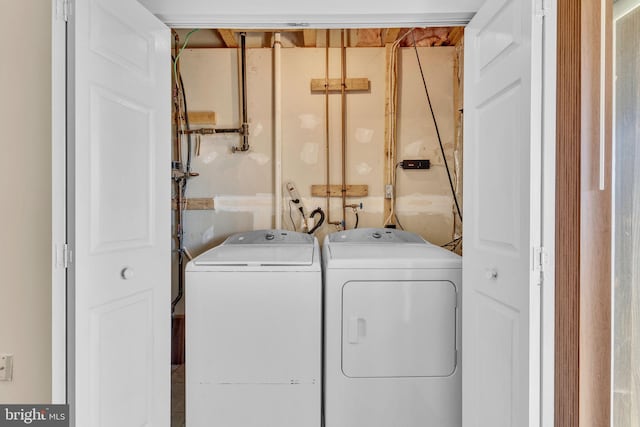 clothes washing area with washer and dryer